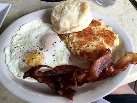 2 eggs over easy with cheesy hash browns bacon and a biscuit, from Ej's Cafe in Naples, FL ...