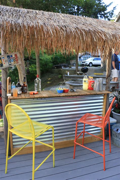 Tiki Bar built from pallet wood and a few 2x4's. Corrugated metal front and some bamboo for the ...