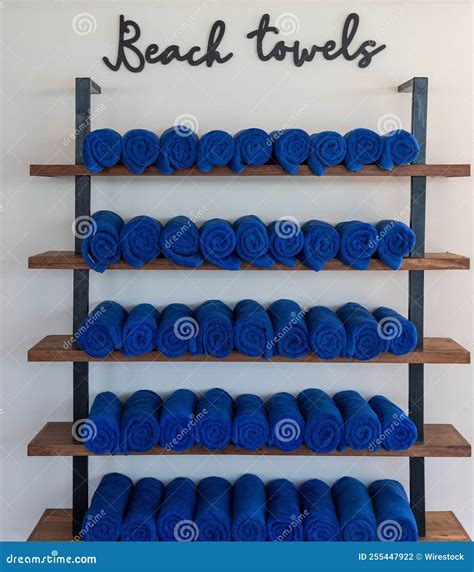 Rows of Neatly Organized Blue Beach Towels on Wooden Shelves Stock ...