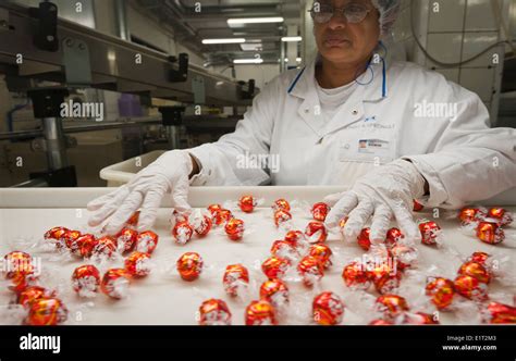 A worker at the Swiss chocolate factory of Lindt & Sprungli in Stock ...