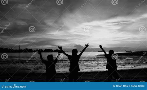 Silhouette Of Children Playing At Beach During Sunset Editorial Photo | CartoonDealer.com #185314655