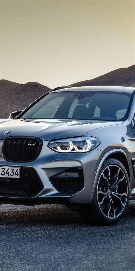 the new bmw x4 suv is shown in front of mountains