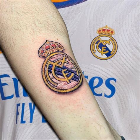 Real Madrid logo patch tattoo located on the shin.