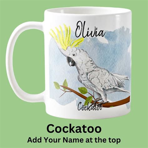 a white coffee mug with an image of a cockatoo on it