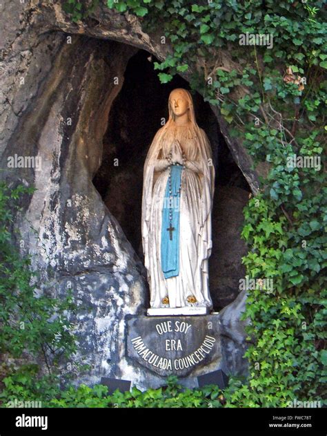 Statue of the Virgin Mary at the holy grotto at Lourdes The French town, set in the Pyrenees ...