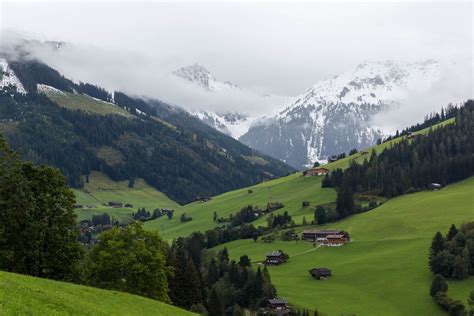 Landscape of the Alpbach valley with typical Tyrolean wooden houses and snowy mountains in the ...