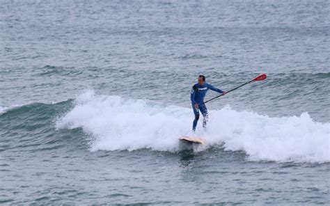 Winter surfing on the beach of San Sebastian (Platja de Sant Sebastià ...