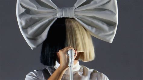 Why Does Sia Cover Her Face With a Wig? Here’s the Answer - Allure