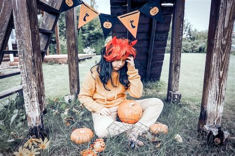 Premium Photo | Girl in costume of devil with red horns in park happy halloween concept