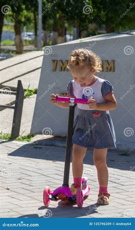 Cute Child Skilfully Skates on a Pink Two-wheeled Scooter on a S Stock Image - Image of leisure ...