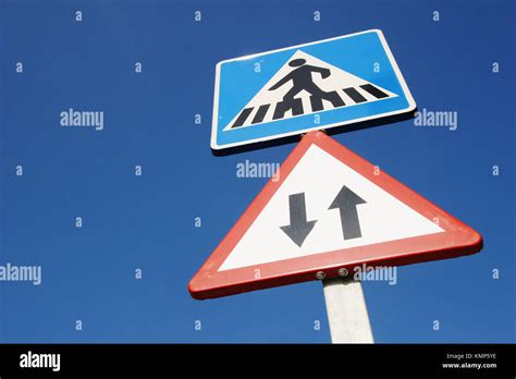 Traffic signs showing pedestrian crossing and advising of two way traffic Stock Photo - Alamy
