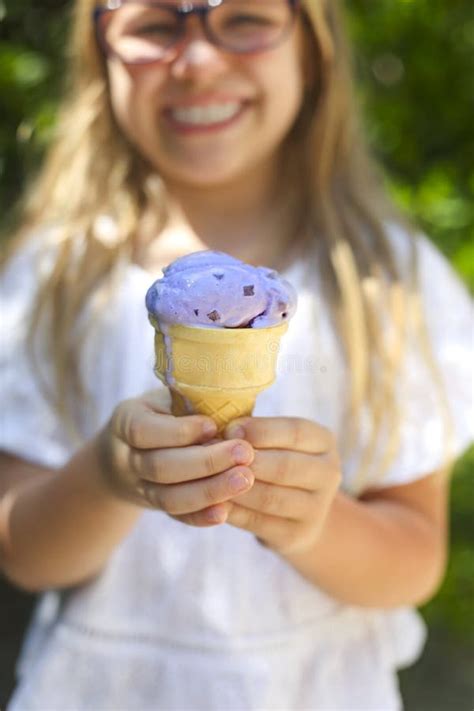 Cute Little Girl with Funny Expression Holding Ice Cream Cone Outside ...