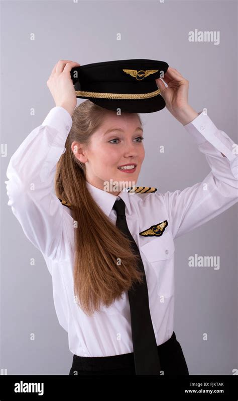 Attractive young female airline pilot in uniform Stock Photo - Alamy