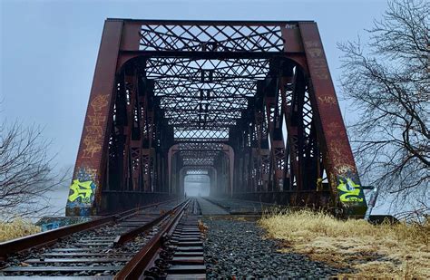 An old railroad bridge finds its way through the fog, connecting Derby and Shelton as it ...