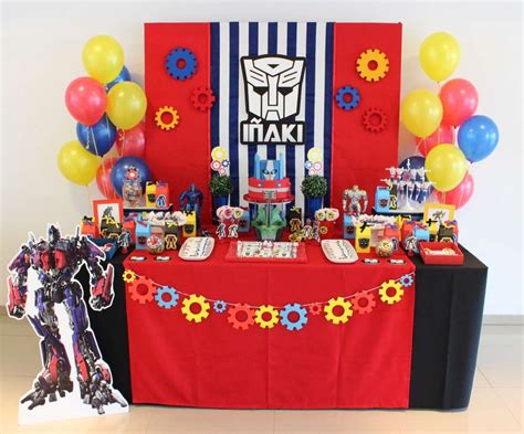 a red table topped with lots of toys and balloons