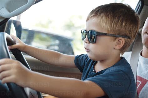 Little boy driving car stock photo