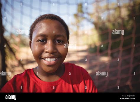 Portrait of happy boy standing in boot camp during obstacle course Stock Photo - Alamy