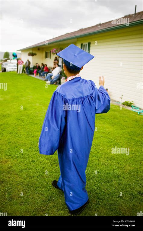 Boy wearing graduation cap and gown Stock Photo - Alamy