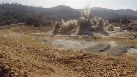 Ground level shot of a dynamite explosion clearing a water channel at the Stock Footage,# ...