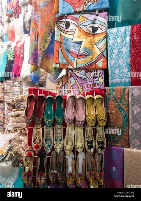 Dubai textile souk (market). Close up of sandals, shawls and colorful fabric Stock Photo - Alamy