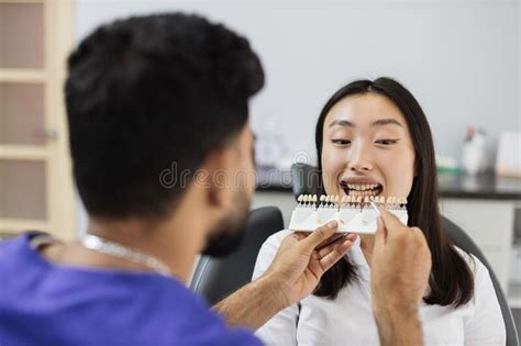 Dentist Choosing Color of Filling from Palette. Stock Photo - Image of female, oral: 263270718