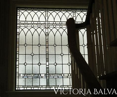 Classic traditional stained, beveled leaded glass stair landing window
