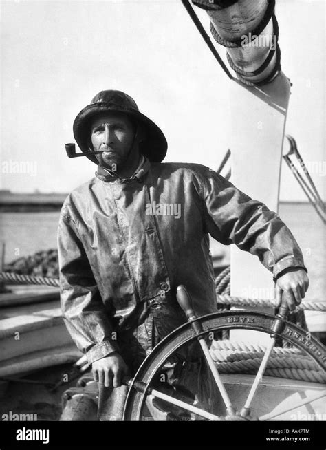 1920s 1930s MAN OLD SALT SAILOR FISHERMAN AT THE HELM OF FISHING BOAT ...