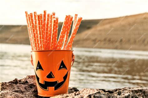 Premium Photo | Cheerful halloween bucket with orange straws