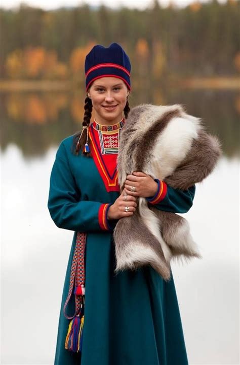 The young woman is wearing her Lule Sami kirtle. http://en.wikipedia ...