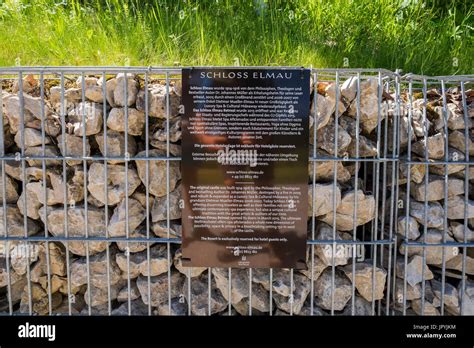 History of Schloss Elmau hotel and Spa on sign attached to stone wall, Bavaria, Germany Stock ...