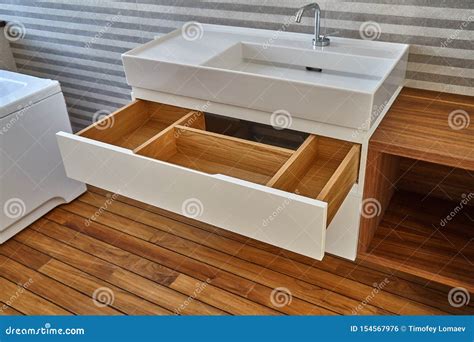 Opened Wooden Drawer of Bathroom Vanity in Luxury Bathroom with Teak Floor. Stylish Interior of ...