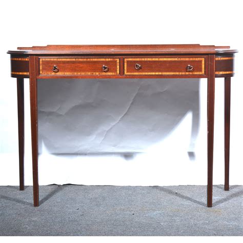 Lot 443 - A reproduction mahogany console table, in