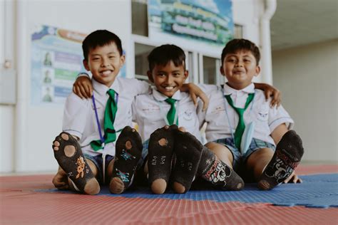 Portrait of Smiling Boys in School Uniforms Sitting on Floor · Free Stock Photo