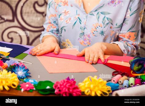 Woman modelling artificial flower from clay Stock Photo - Alamy