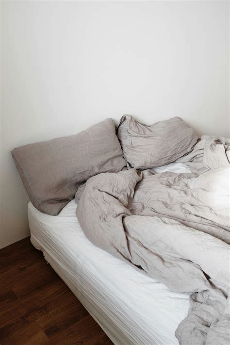 Unmade bed with pillows and blanket in light bedroom · Free Stock Photo