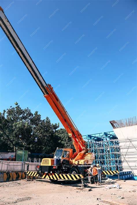 Premium Photo | Crane trucks at construction site