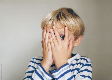 "Scared Child Peeking Between His Fingers" by Stocksy Contributor ...