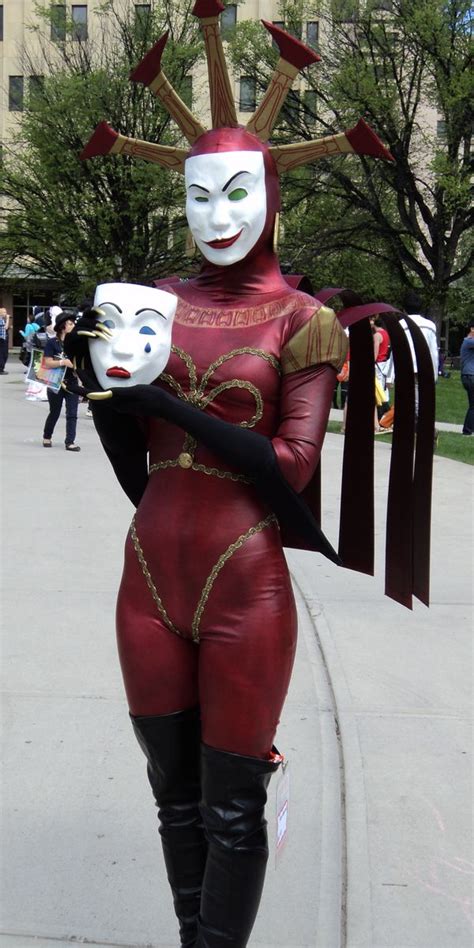 a person in a costume holding a mask