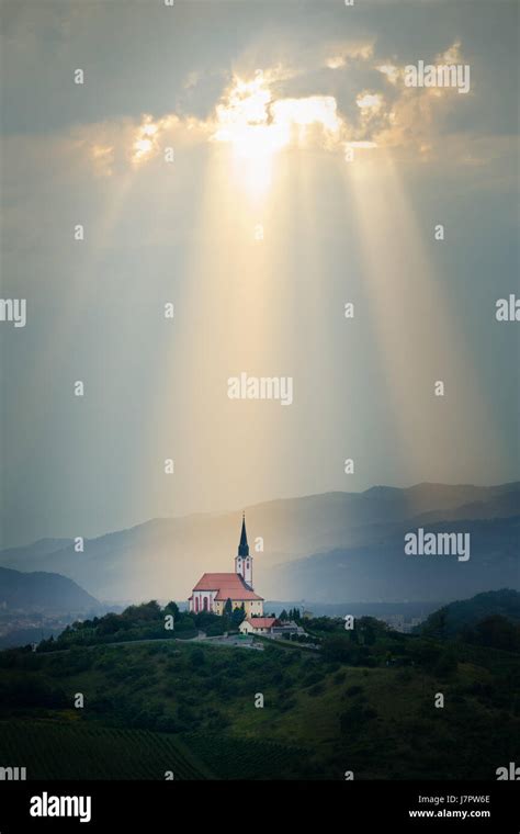 Sun rays shining down on a Church Stock Photo - Alamy