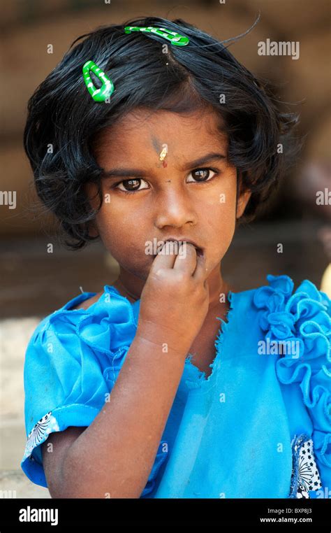 Indian village girl eating wearing a blue dress. Andhra Pradesh, India Stock Photo - Alamy