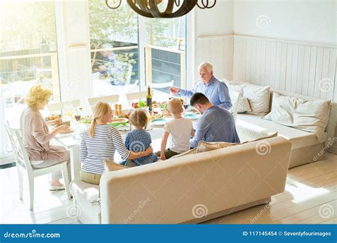 Big Family at Dinner Table stock photo. Image of sunlight - 117145454