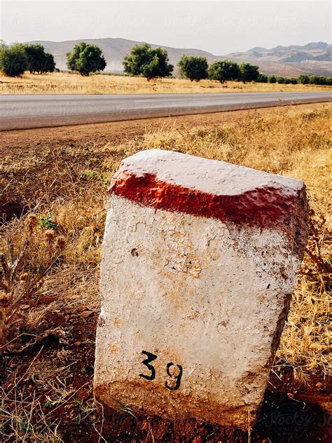 "Mile Stone 39 On Side Of A Dry Road" by Stocksy Contributor "VISUALSPECTRUM" - Stocksy