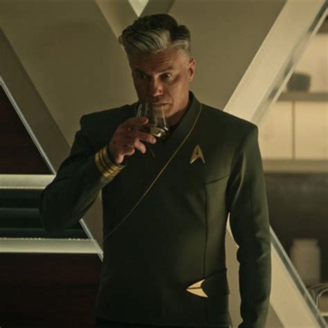 a man in a star trek uniform holding a cell phone