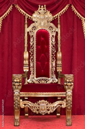 Red royal chair on a background of red curtains. Place for the king ...