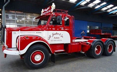 a red and white truck parked in a garage