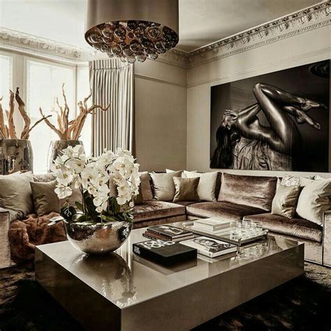 a living room filled with lots of furniture and flowers on top of a coffee table