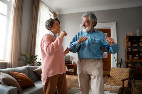 Free Photo | Medium shot old couple dancing at home