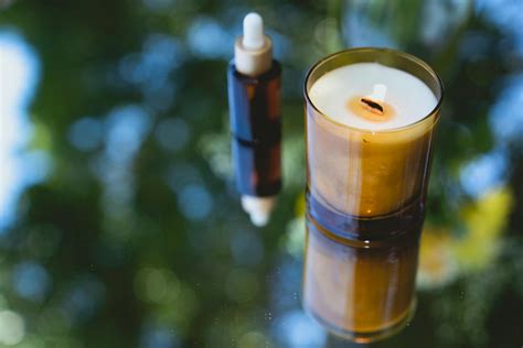 Aromatic burning candle with essential oil in bottle · Free Stock Photo