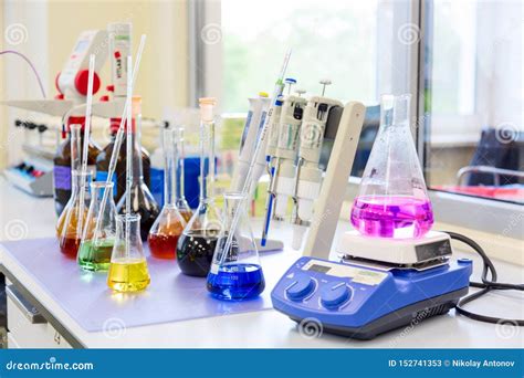 Chemical Analysis, Pharmacology and Laboratory Concept. Flasks and Scales with Colored Liquid ...