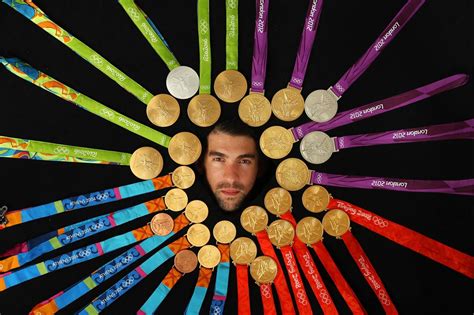 Michael Phelps poses with all 28 of his Olympic medals, 23 of them gold, during an SI photo ...